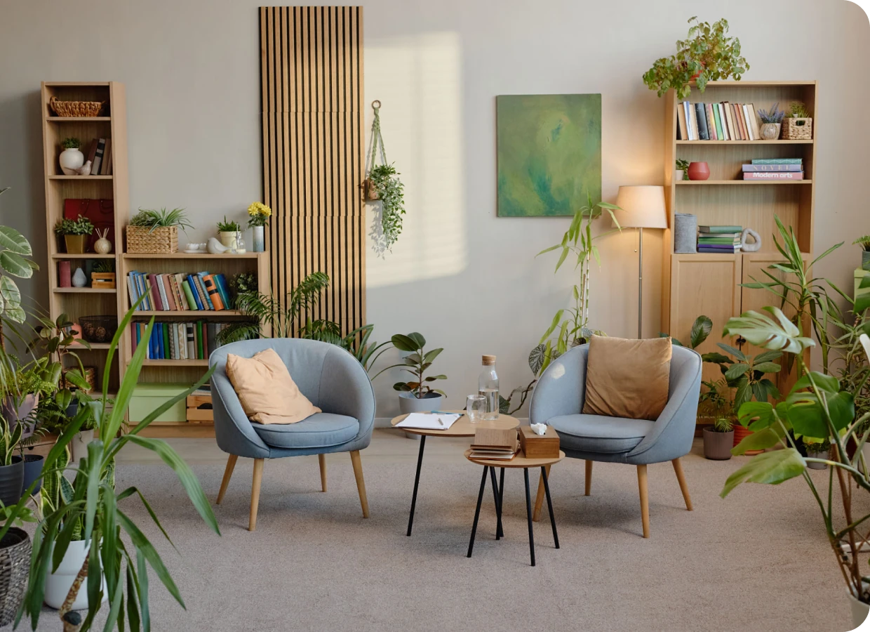Modern living space with bookshelves and greenery.