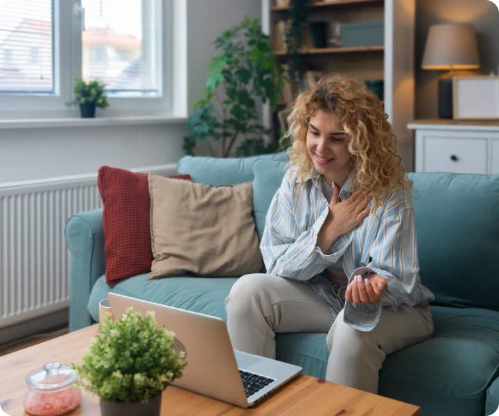 Relaxed woman on sofa using laptop